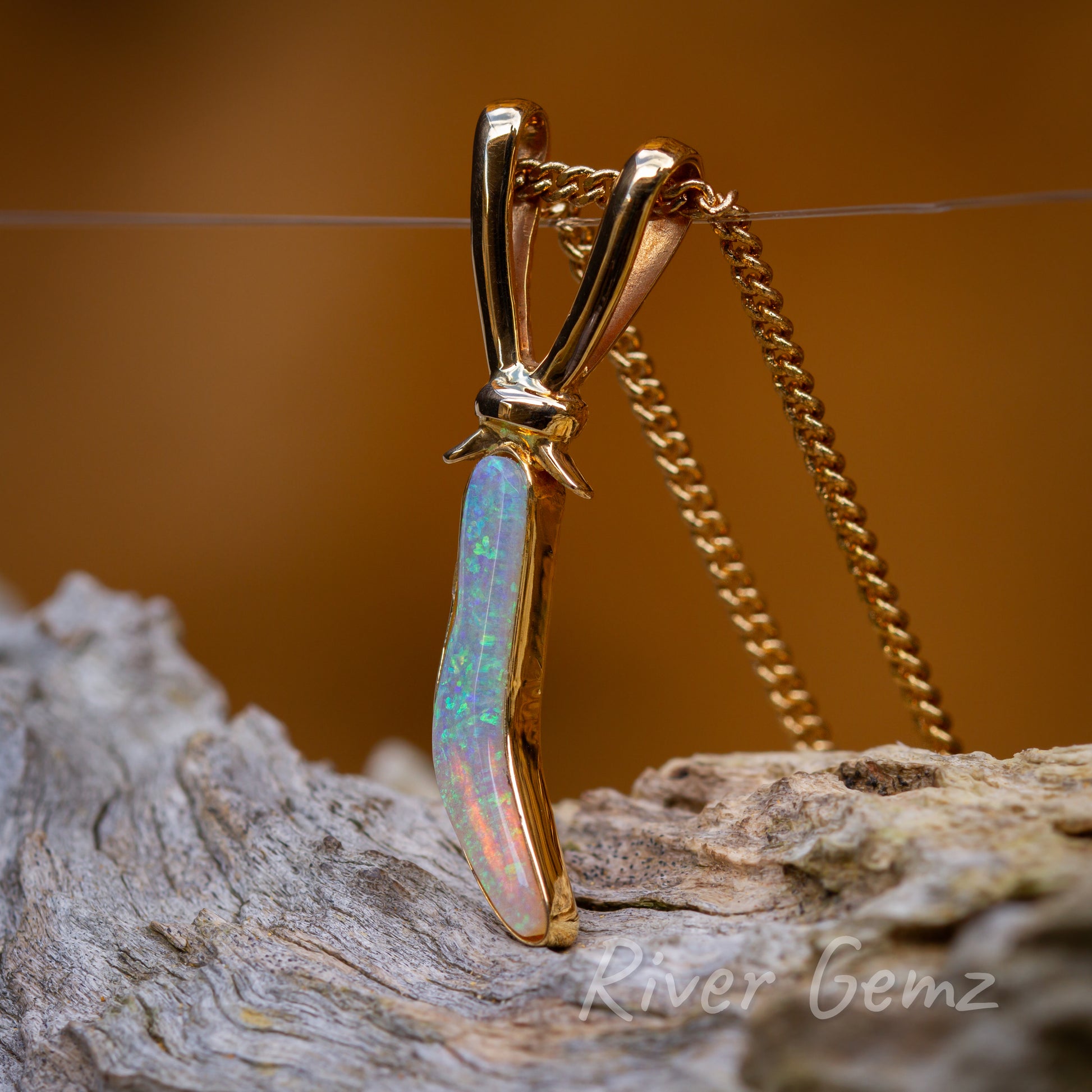 Side on view showing bail-ears on top of boomerang pendant.