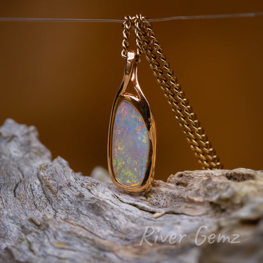 Gold Australian Opal pendant with the bail forming part of the besel setting.