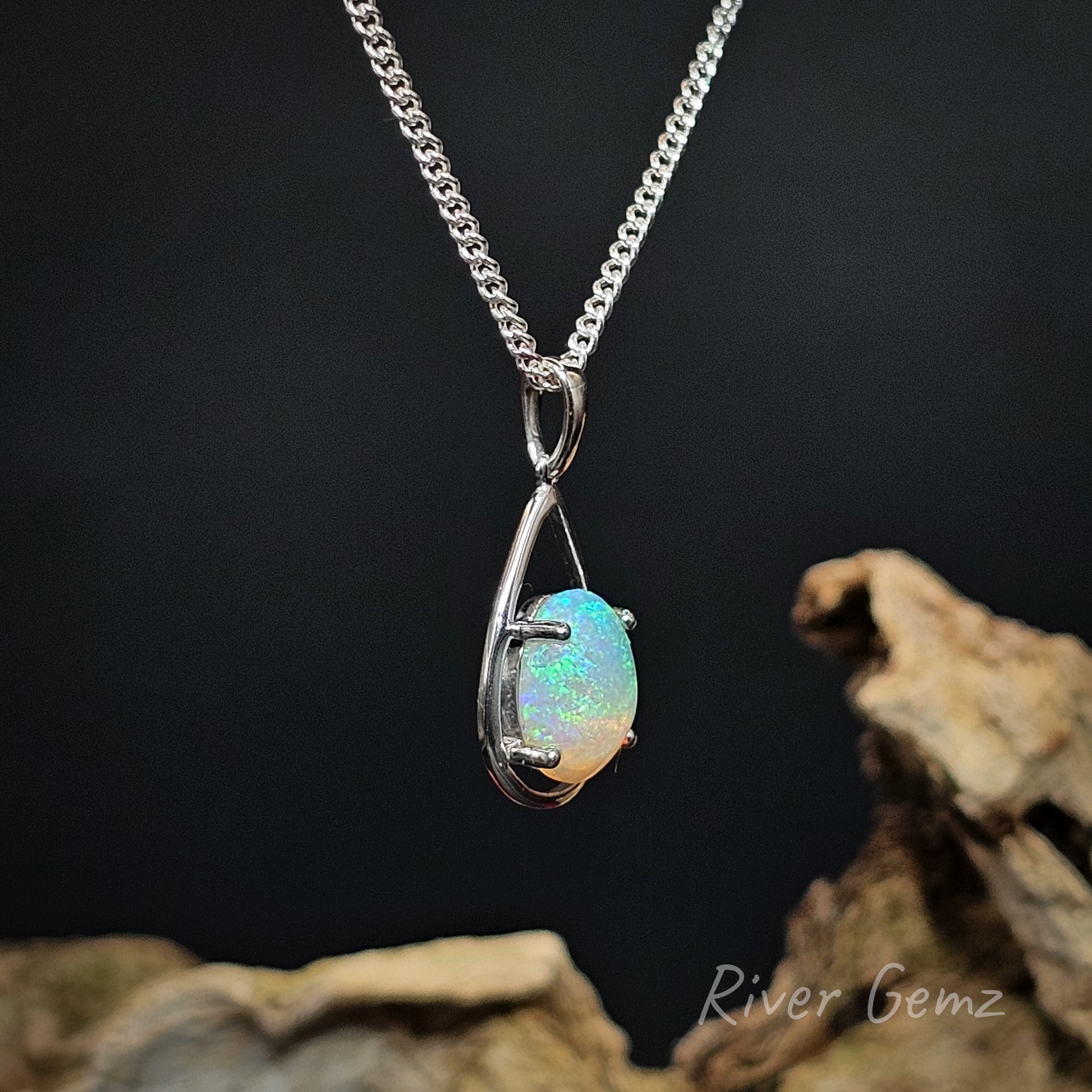 Opal pendant necklace on a dark background with 'River Gemz' branding.
