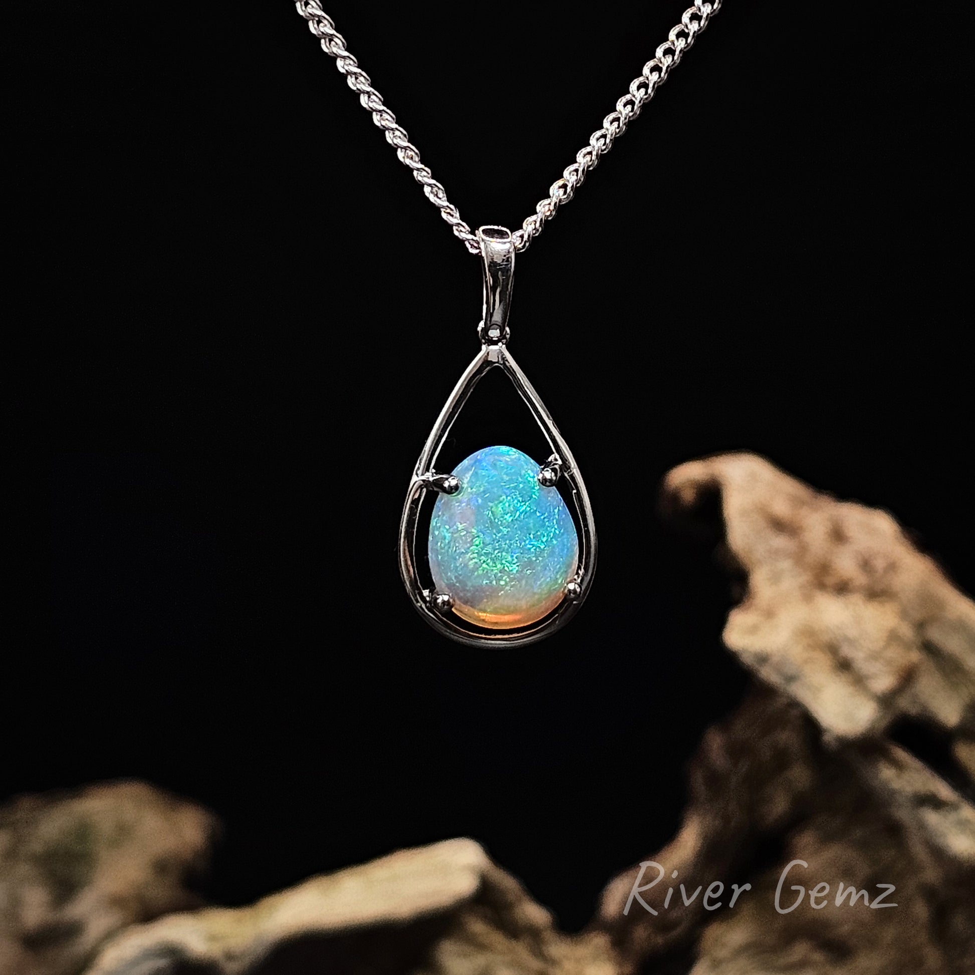 Opal pendant necklace on a dark background with 'River Gemz' branding.