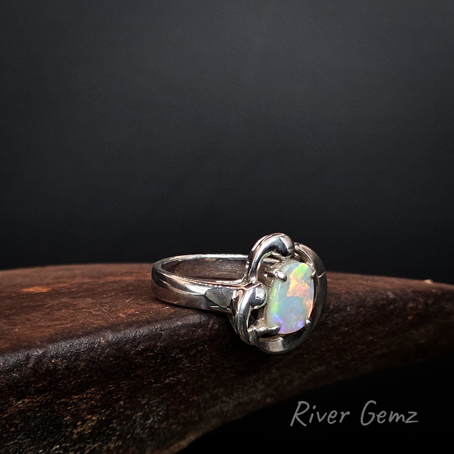 Light opal claw set in sterling silver ring.