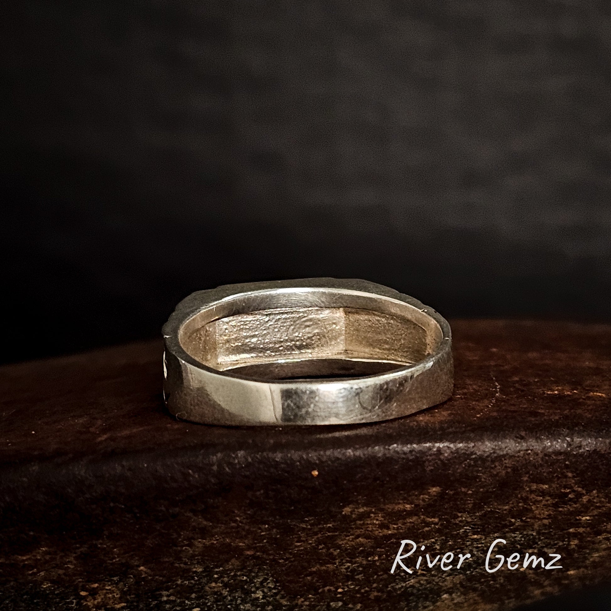 Back of ring shows the silver inlay on a dark surface with 'River Gemz' branding.