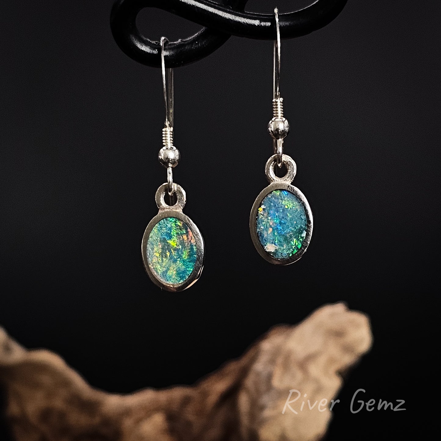 Opal earrings on a dark background with 'River Gemz' branding.