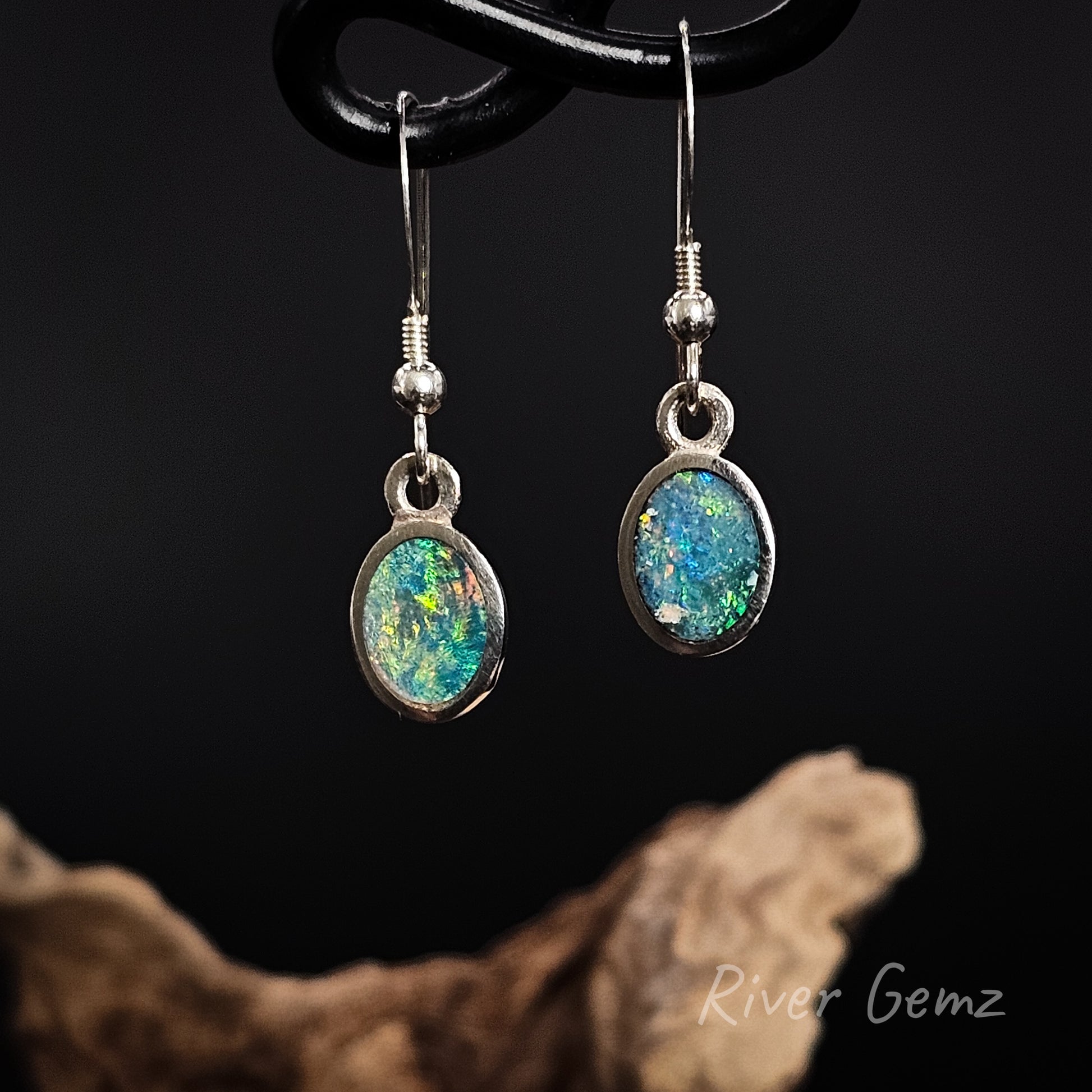 Opal earrings on a dark background with 'River Gemz' branding.