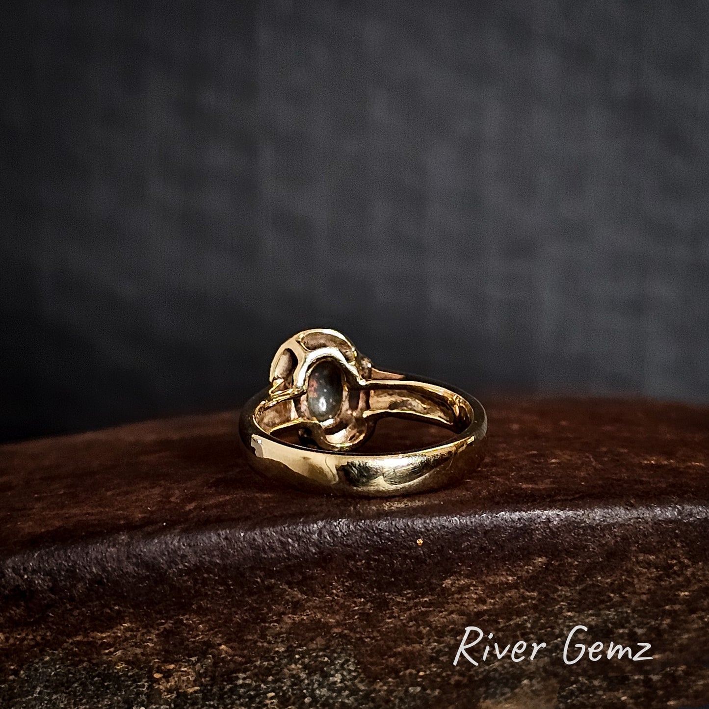 Rear view of the ring shows the dark base tone of the semi-black opal.