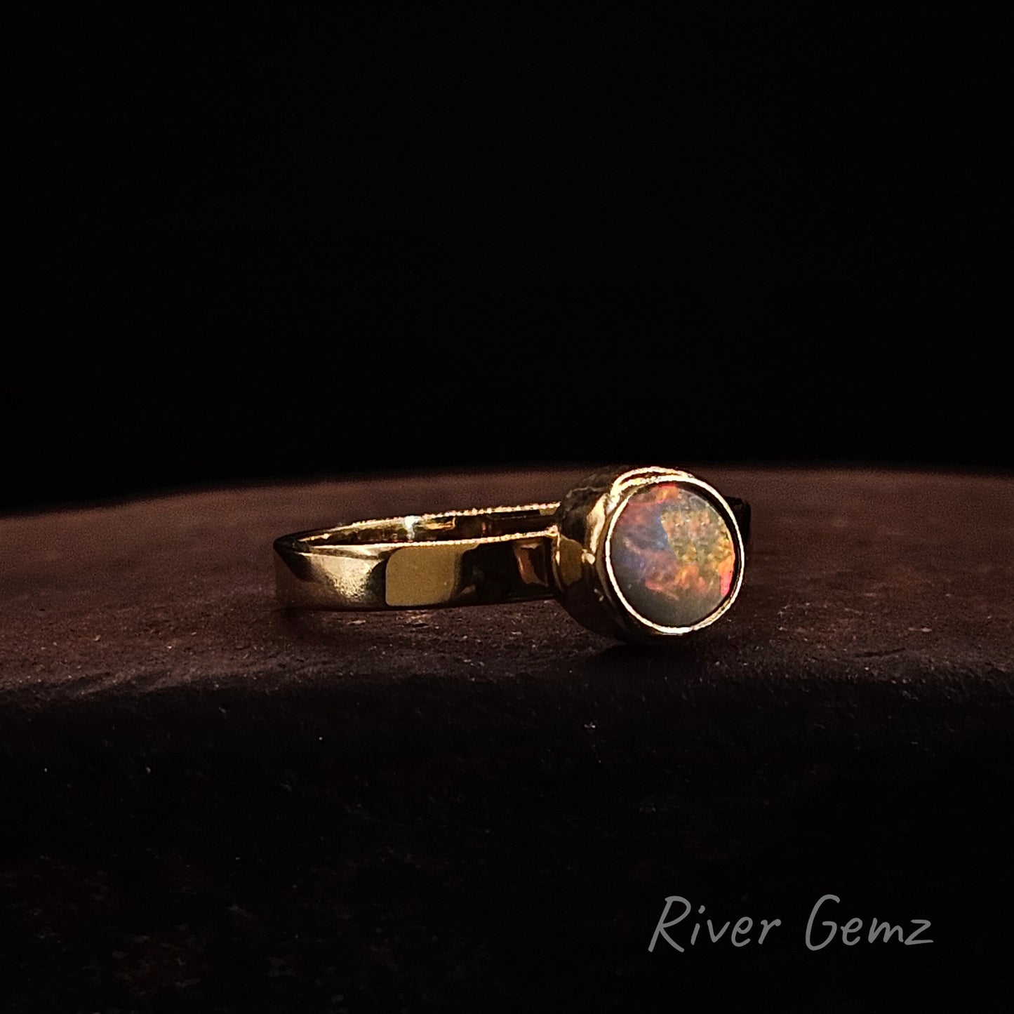Fire red and yellow opal full besel set in yellow gold ring.