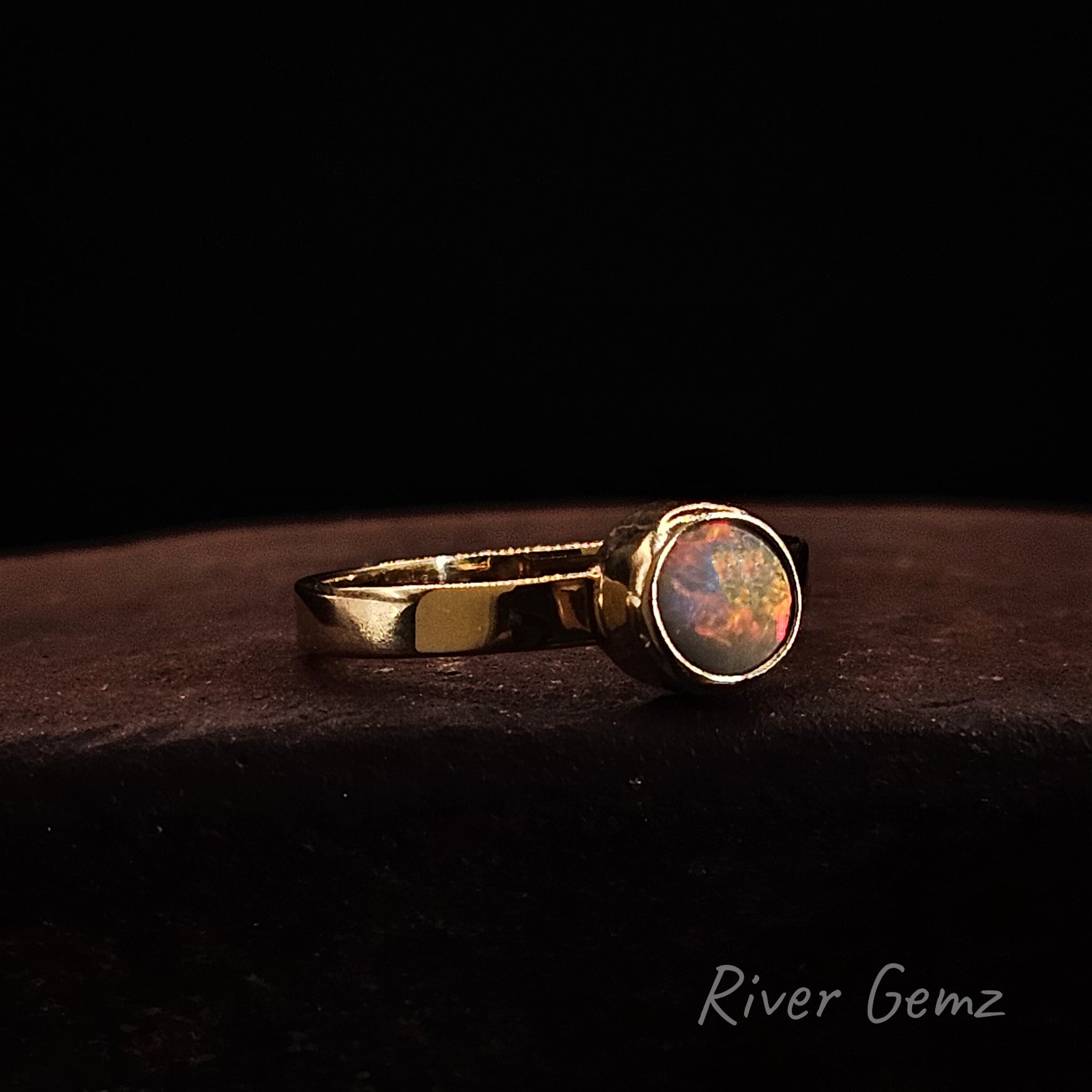 Fire red and yellow opal full besel set in yellow gold ring.