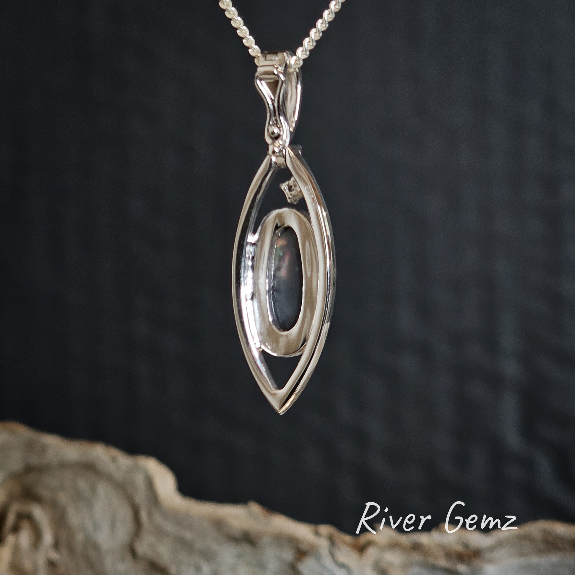 Rear view of the pendant shows the black base of the solid semi-black opal.