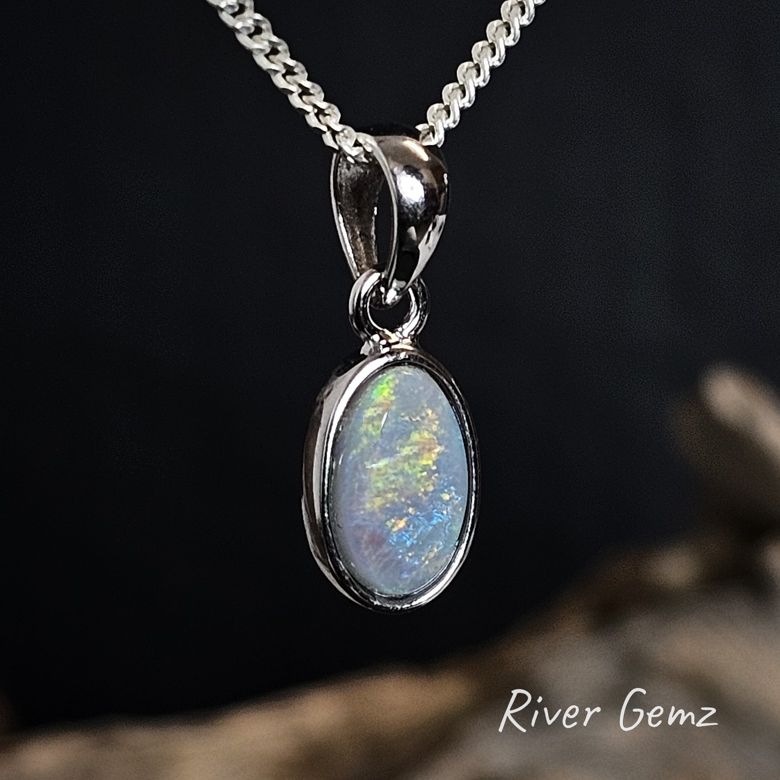Opal pendant necklace on a dark background with 'River Gemz' branding.