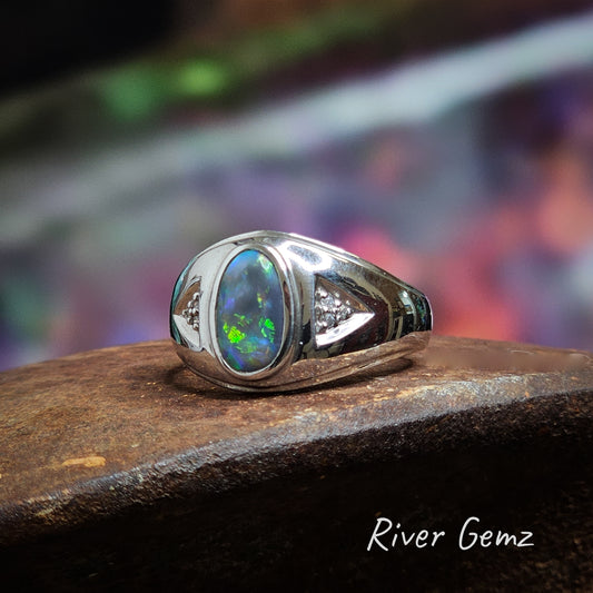 Oval shaped dark based opal ring besel set in men's silver ring.