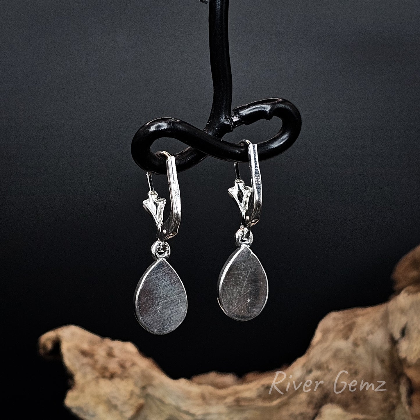 Rear view of earrings shows the full sterling silver backing behind the opals.