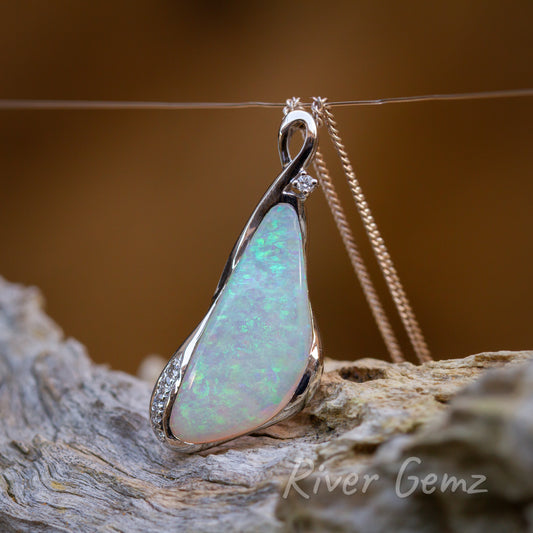 Modern design pendant with triangular shaped opal the feature & bail part of opal setting.