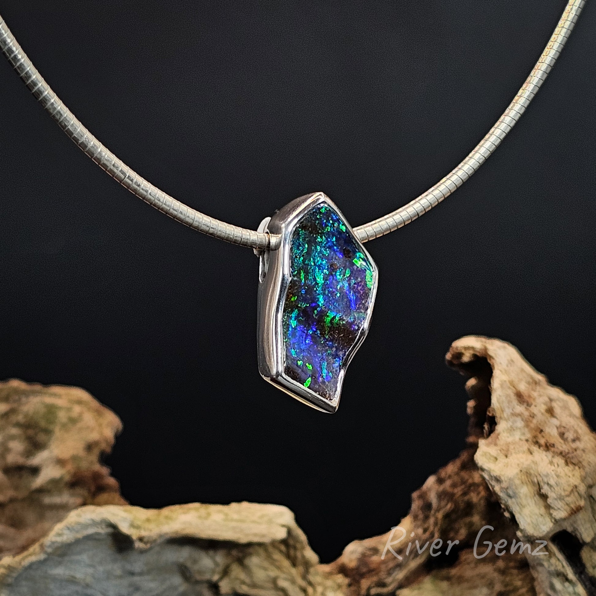Necklace with a colorful pendant on a dark background