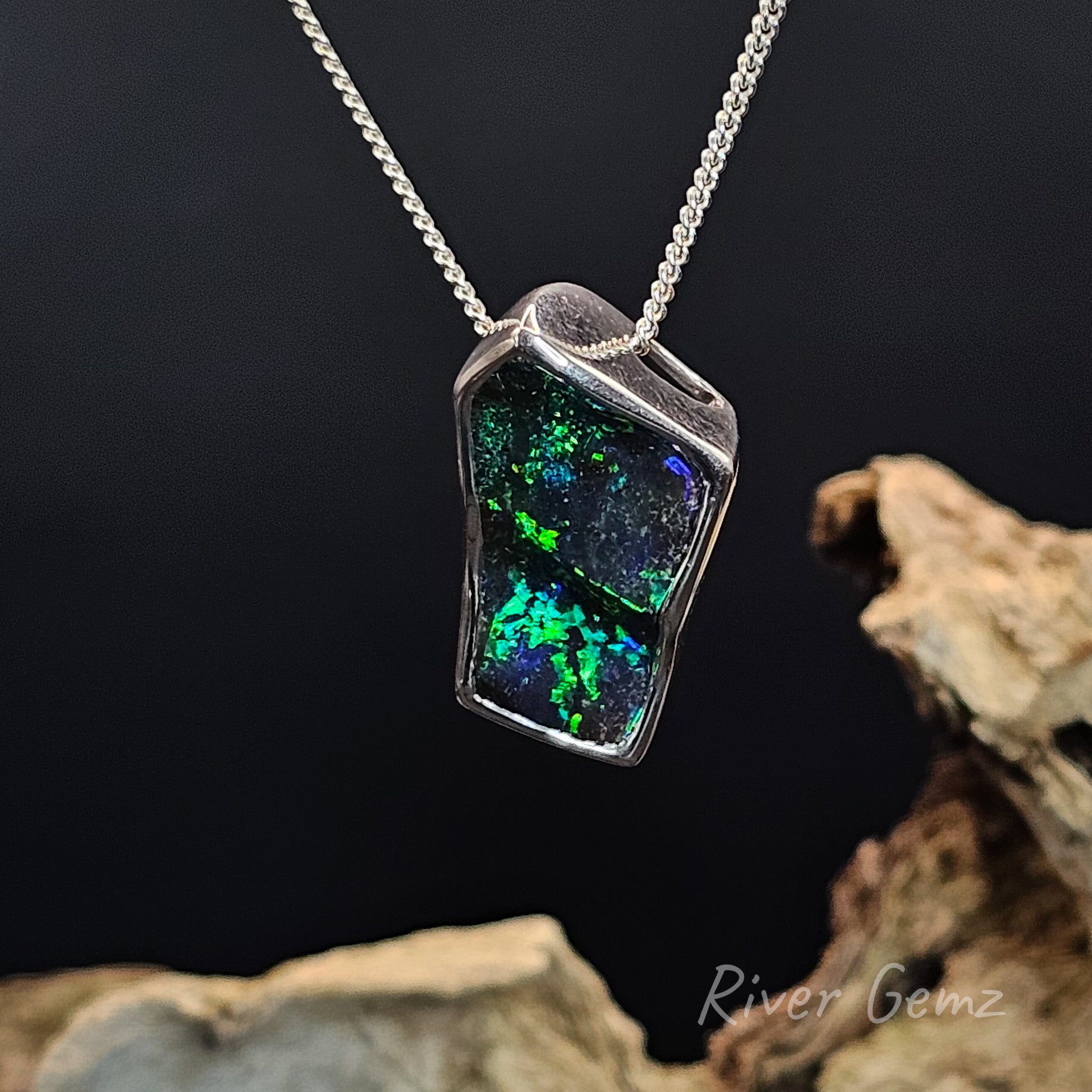 Dark green free-form cut boulder opal besel set in sterling silver necklace.