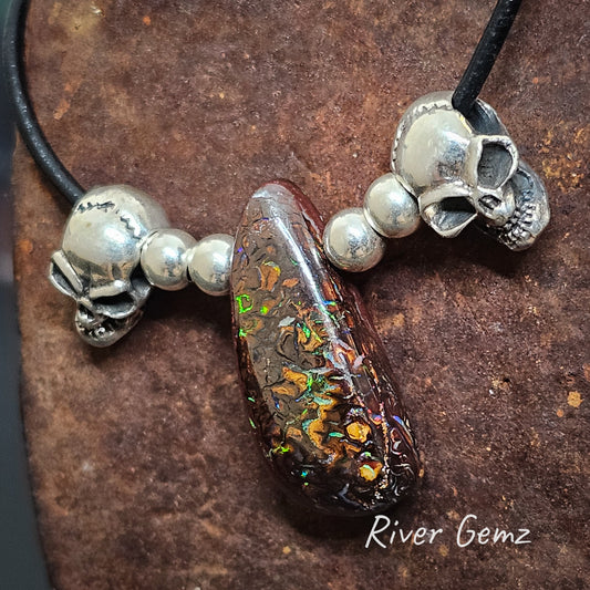 Skulls, beads and boulder matrix opal strung on leather necklace.