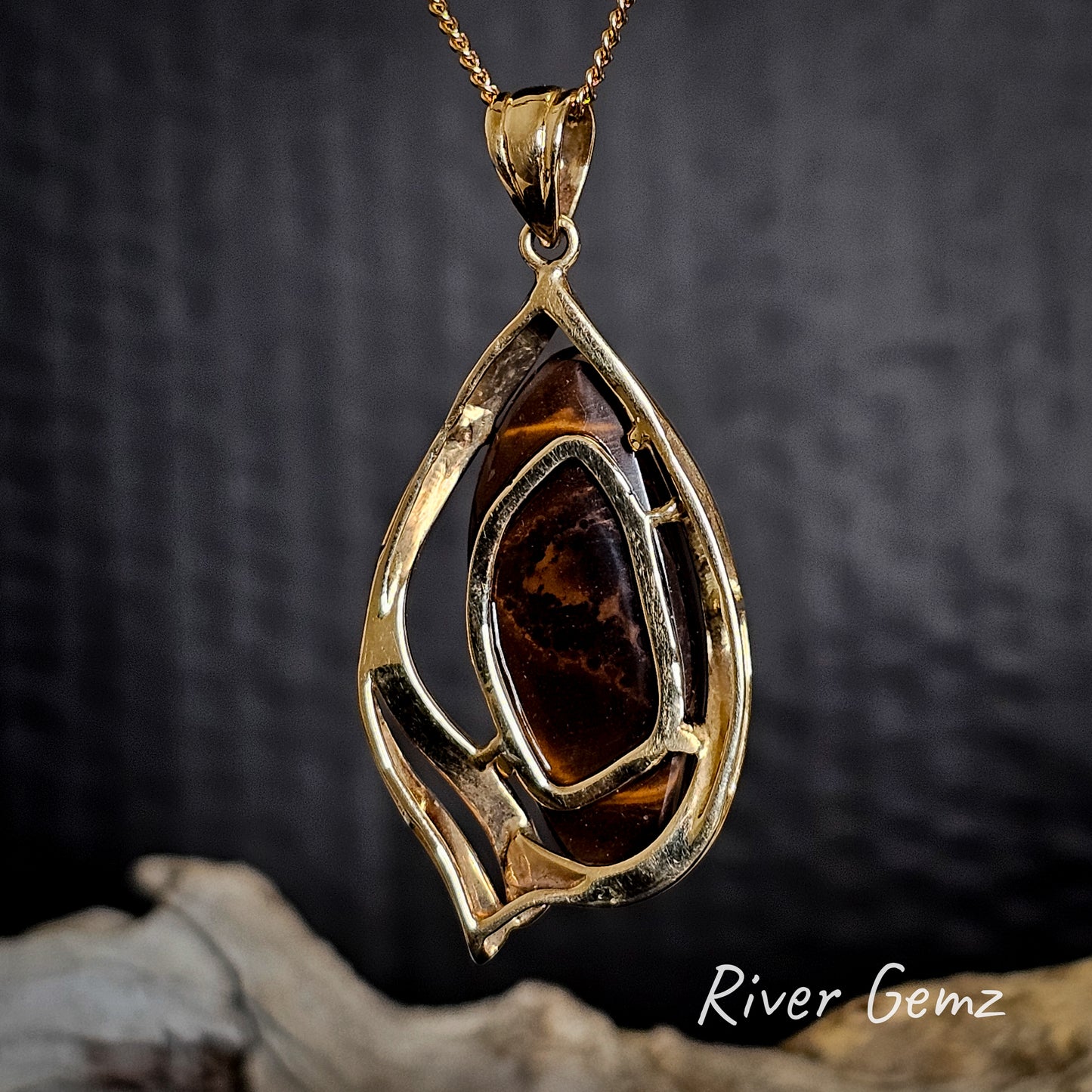 Rear view of the gold pendant shows the ironstone matrix of the boulder opal on a dark background, featuring 'River Gemz' branding.