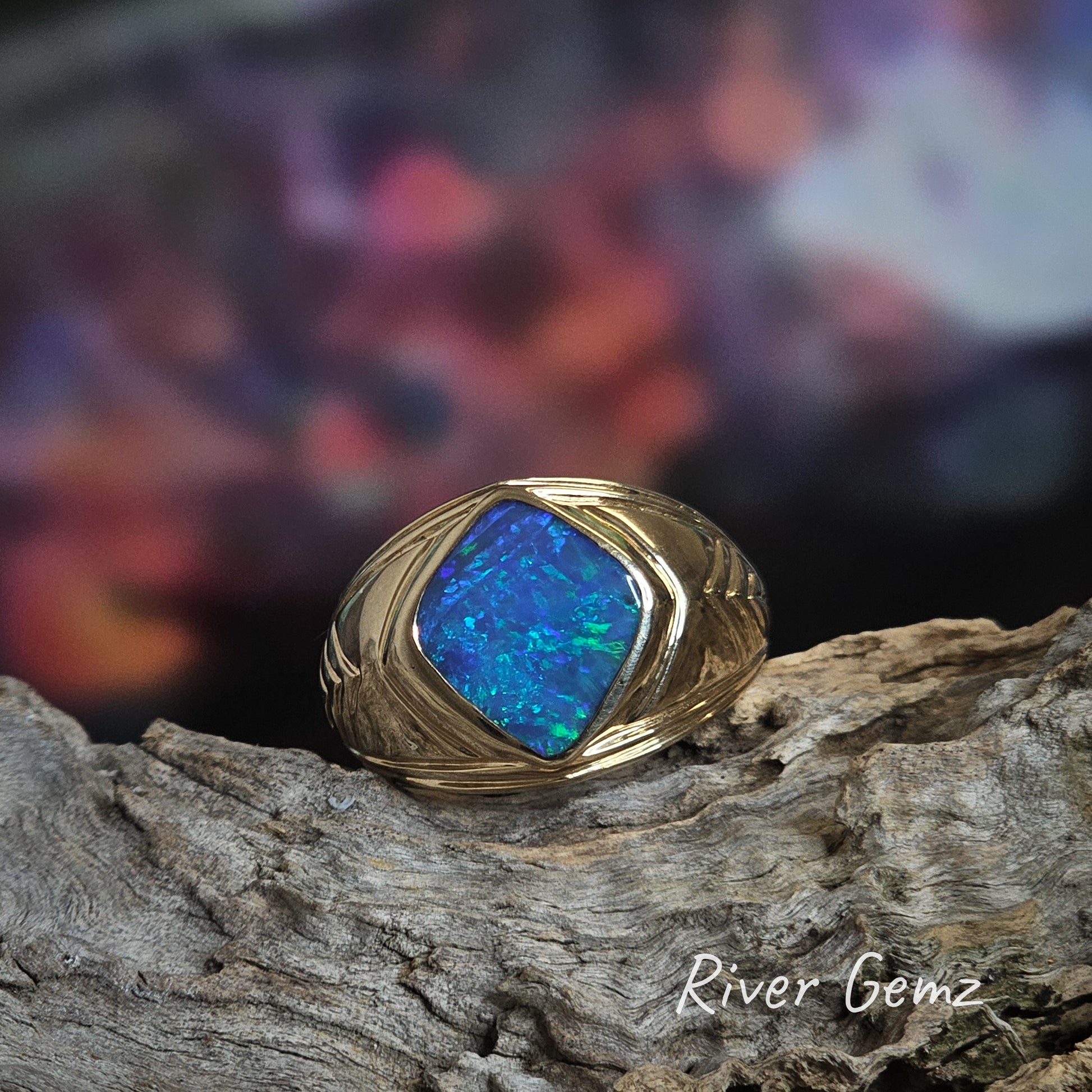 Diamond shaped blue-green opal set in men's yellow gold dress ring.