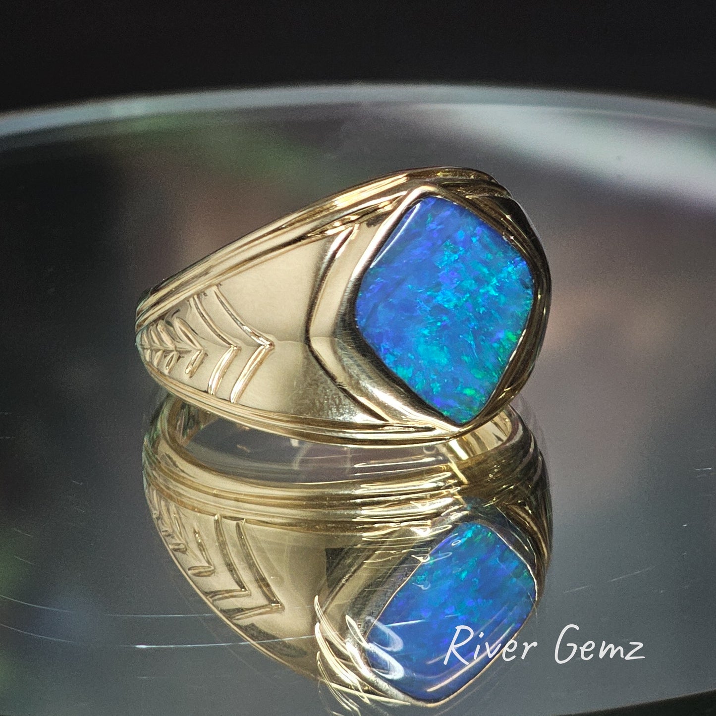 Blue and green dark opal besel set in stylish gold men's ring.