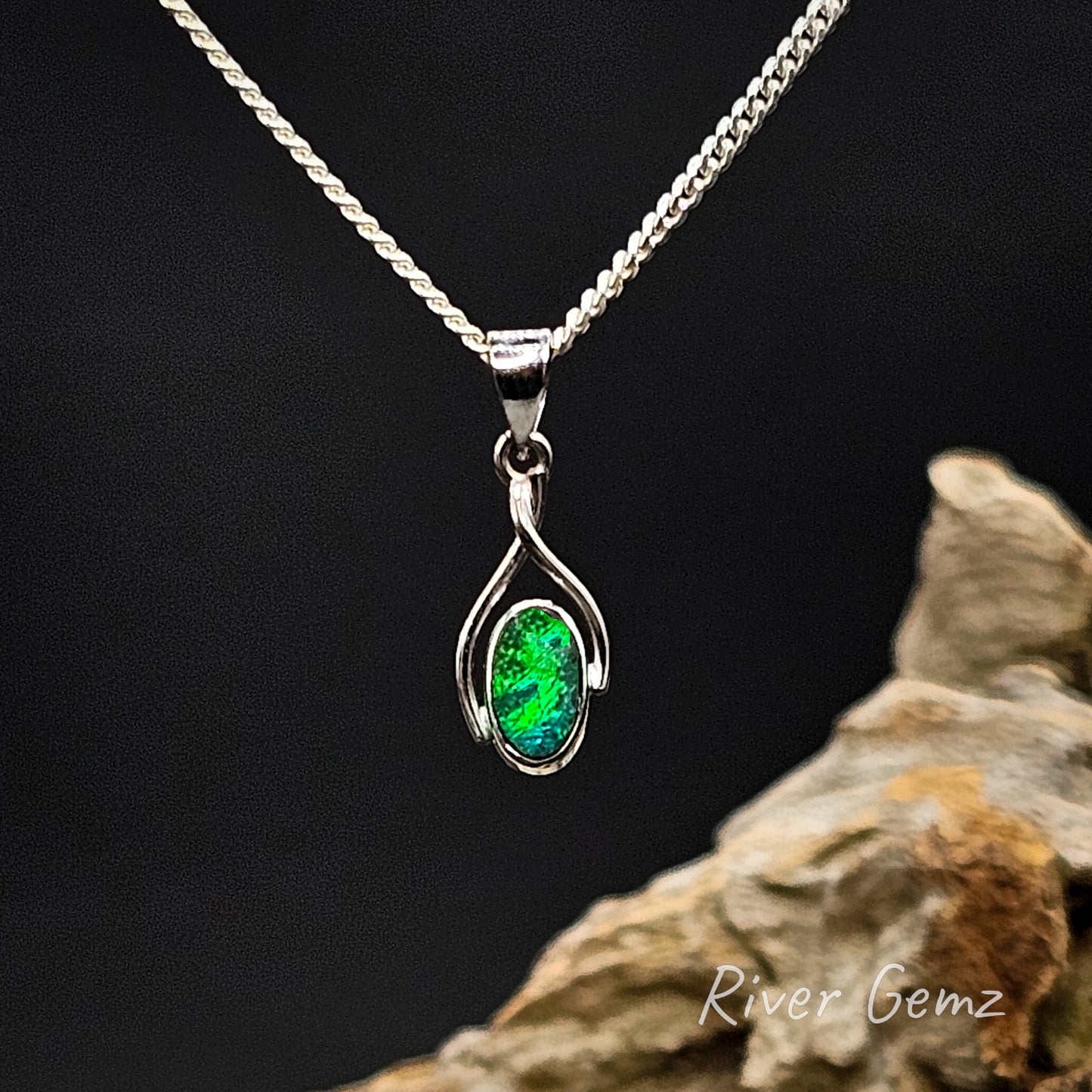 Green opal set in white gold pendant on a silver chain against a dark background with 'River Gemz' branding.