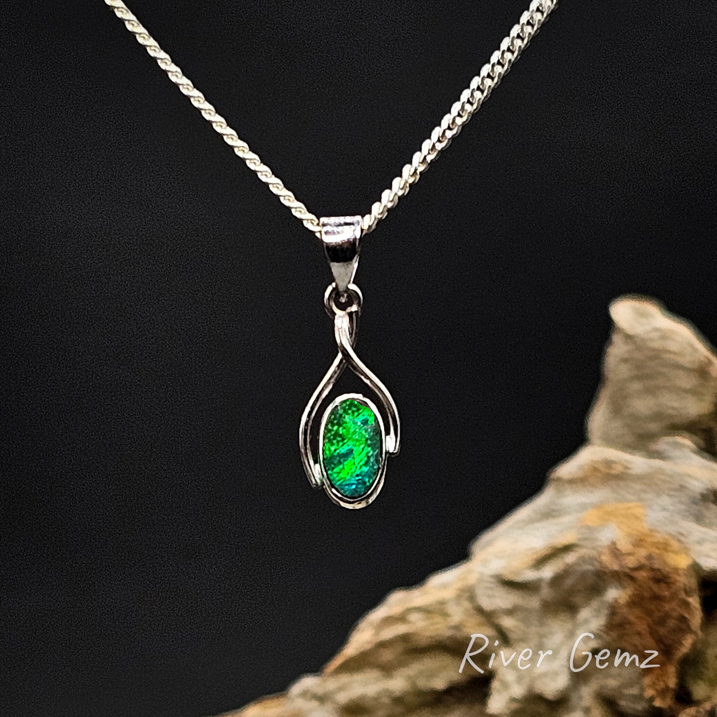 Green opal set in white gold pendant on a silver chain against a dark background with 'River Gemz' branding.