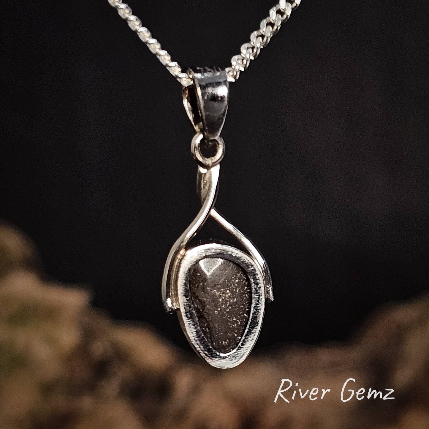 Rear of pendant showing the ironstone matrix of the boulder opal against a dark background, branded 'River Gemz'.