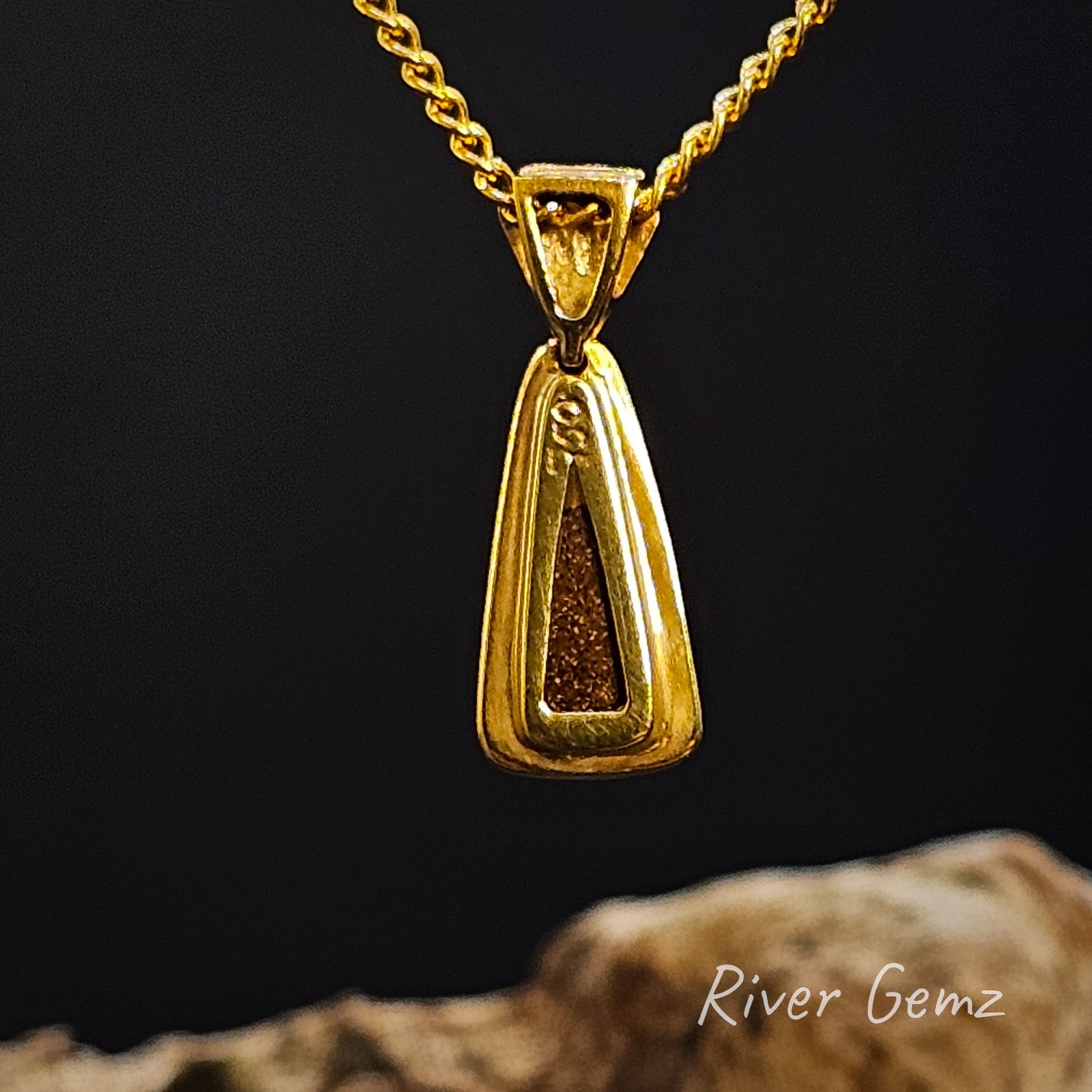 Rear view of the necklace shows the 750 stamp for 18K gold and the ironstone matrix of the boulder opal.