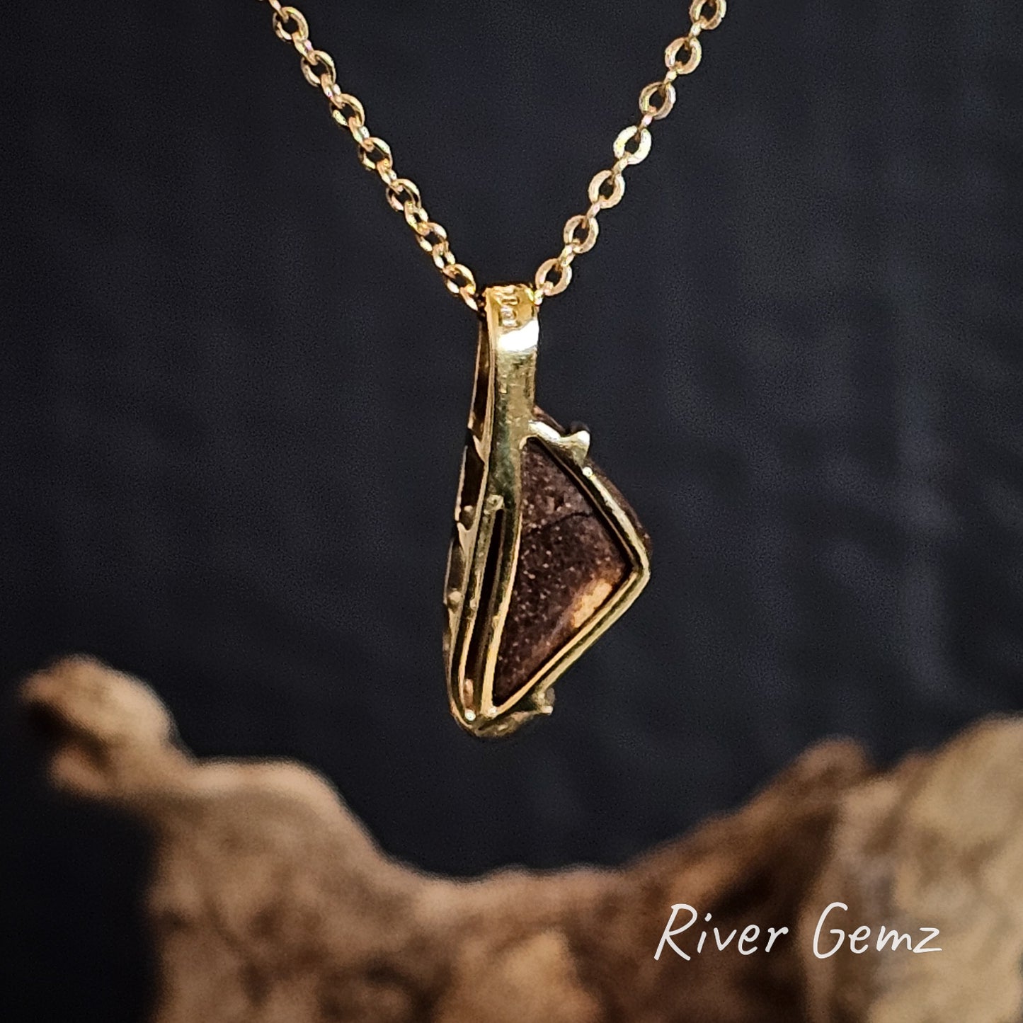 Back of the gold pendant shows the ironstone matrix of the boulder opal on a dark background, featuring 'River Gemz' branding.