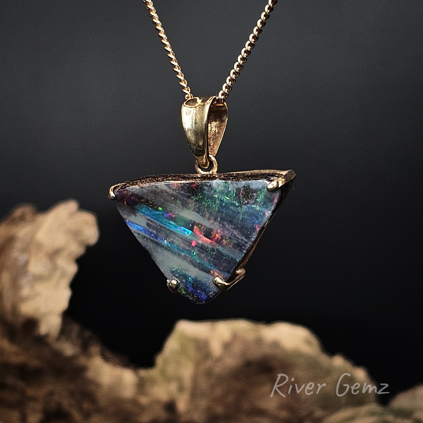 Opal pendant on a chain with a dark background