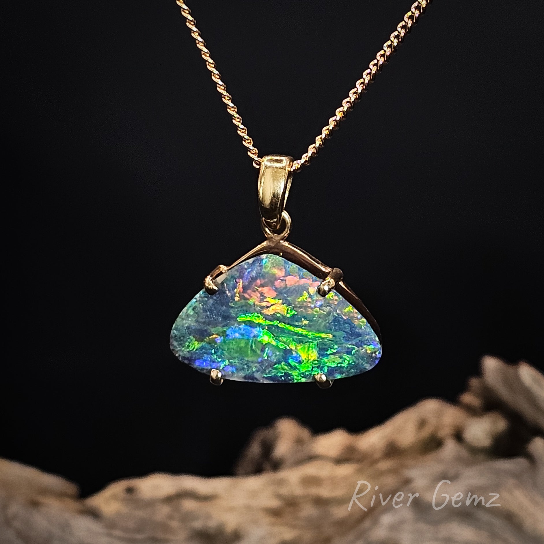 Opal pendant necklace on a dark background with 'River Gemz' branding.