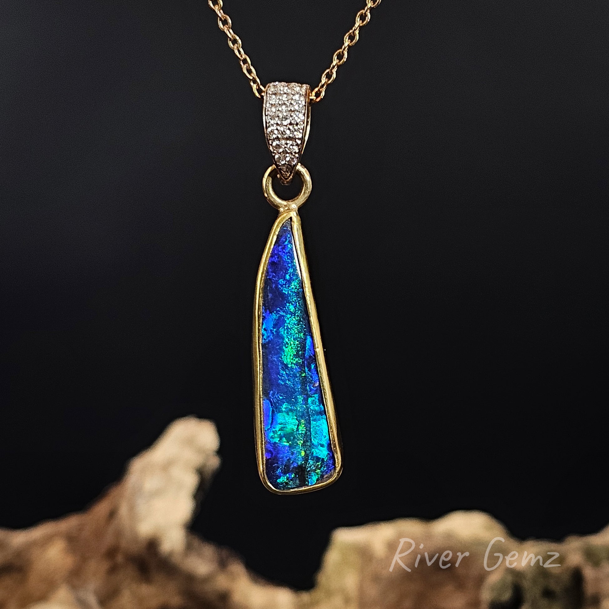 Opal pendant necklace with gold chain on a dark background