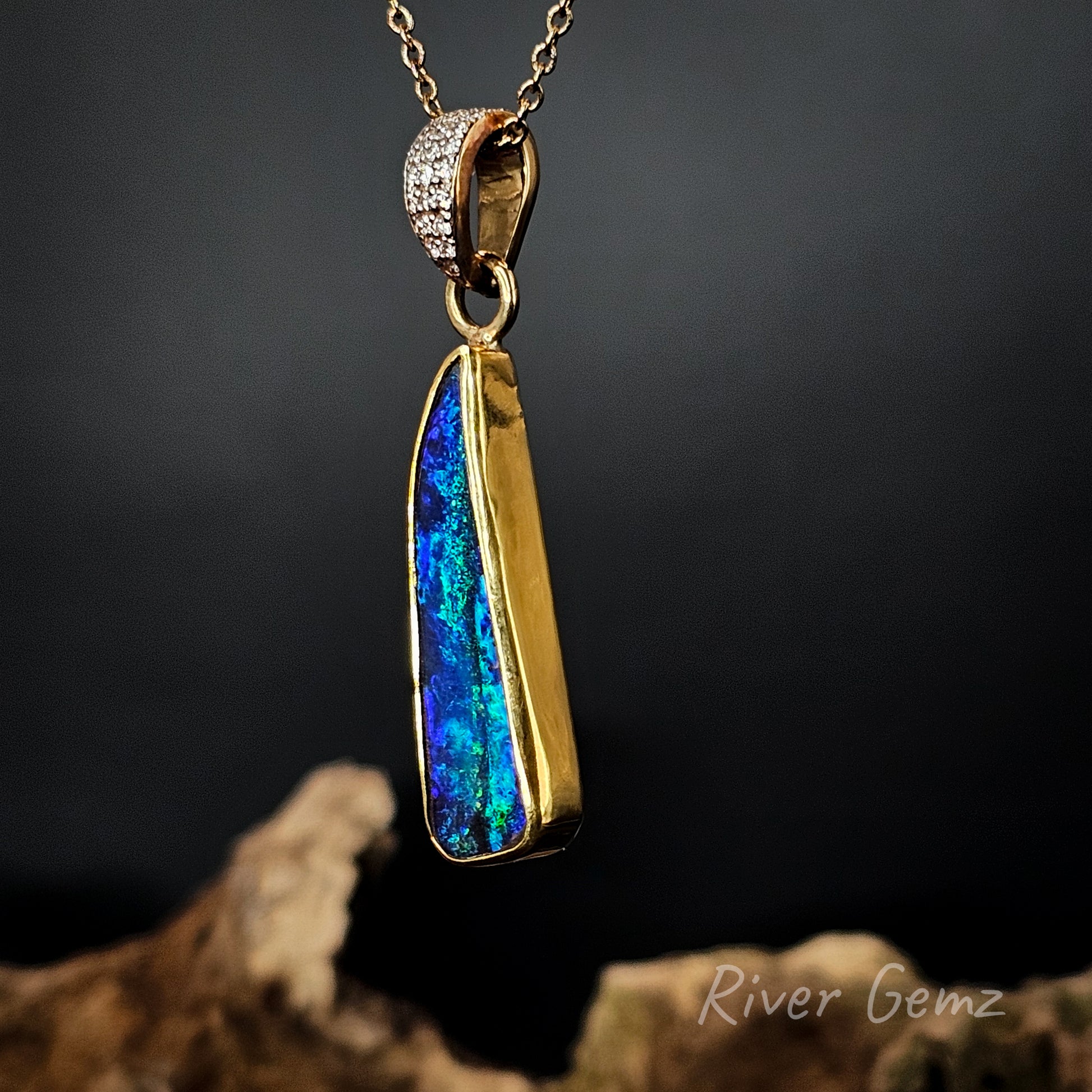 Opal and diamonds set in yellow gold necklace on a dark background, featuring 'River Gemz' branding.