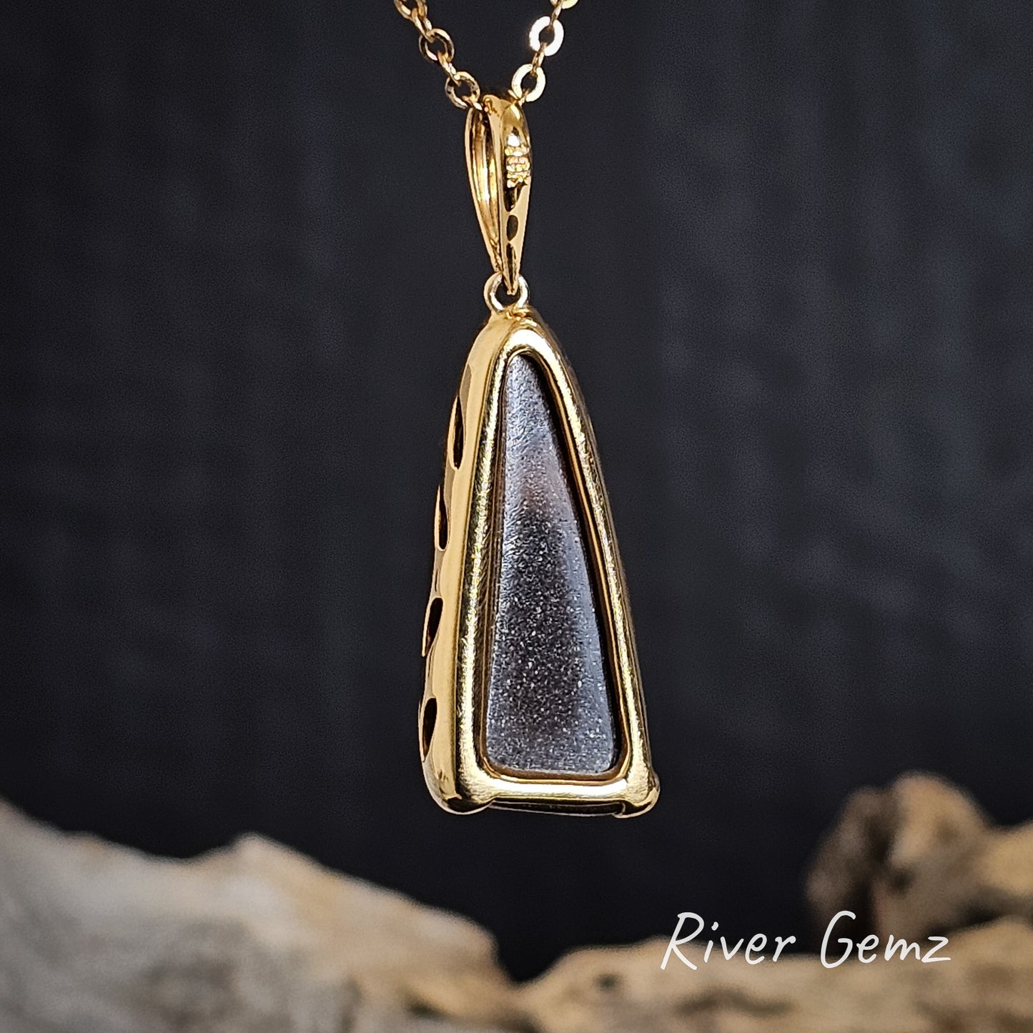 Back of gold pendant shows the ironstone matrix of the boulder opal on a dark background, featuring 'River Gemz' branding.