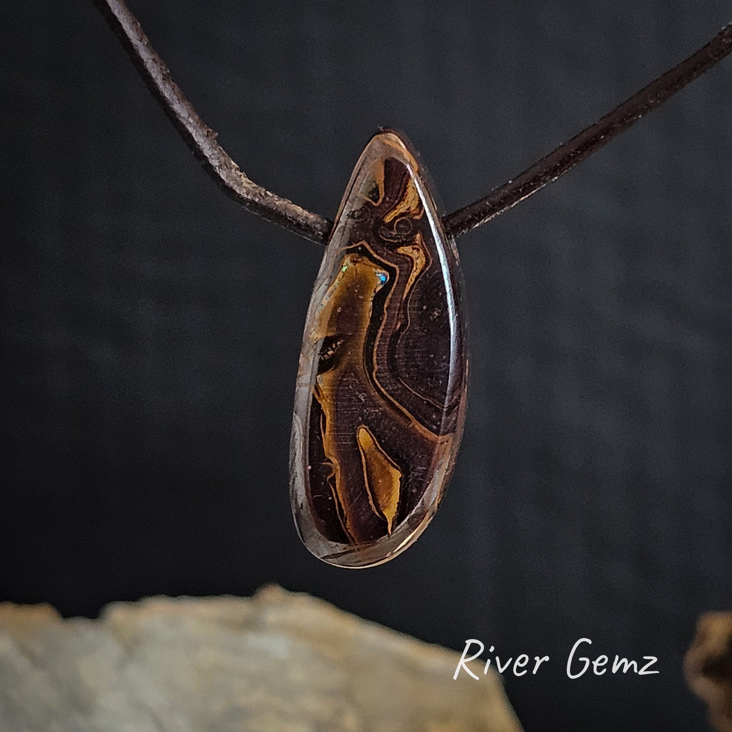 Rear view shows the brown ironstone of the solid boulder opal.
