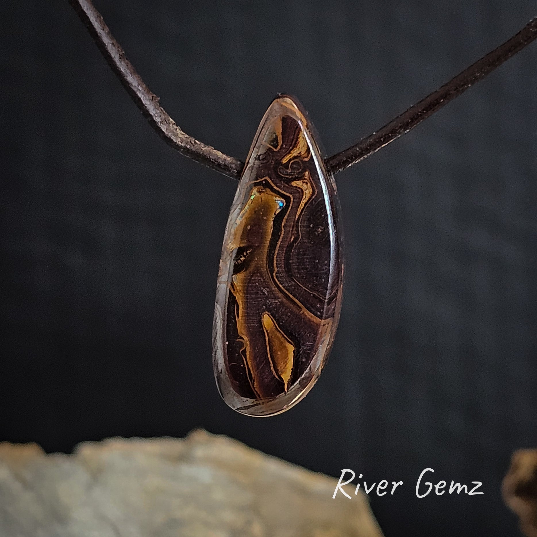 Rear view shows the brown ironstone of the solid boulder opal.