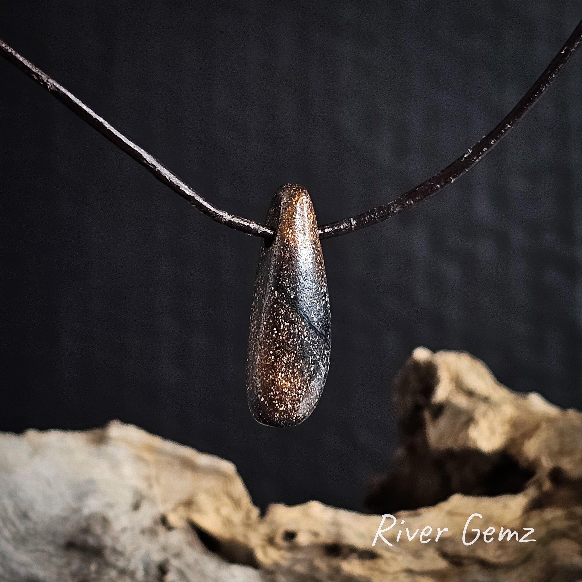 Rear view shows the ironstone matrix of the boulder in the pendant on a dark background with 'River Gemz' branding.