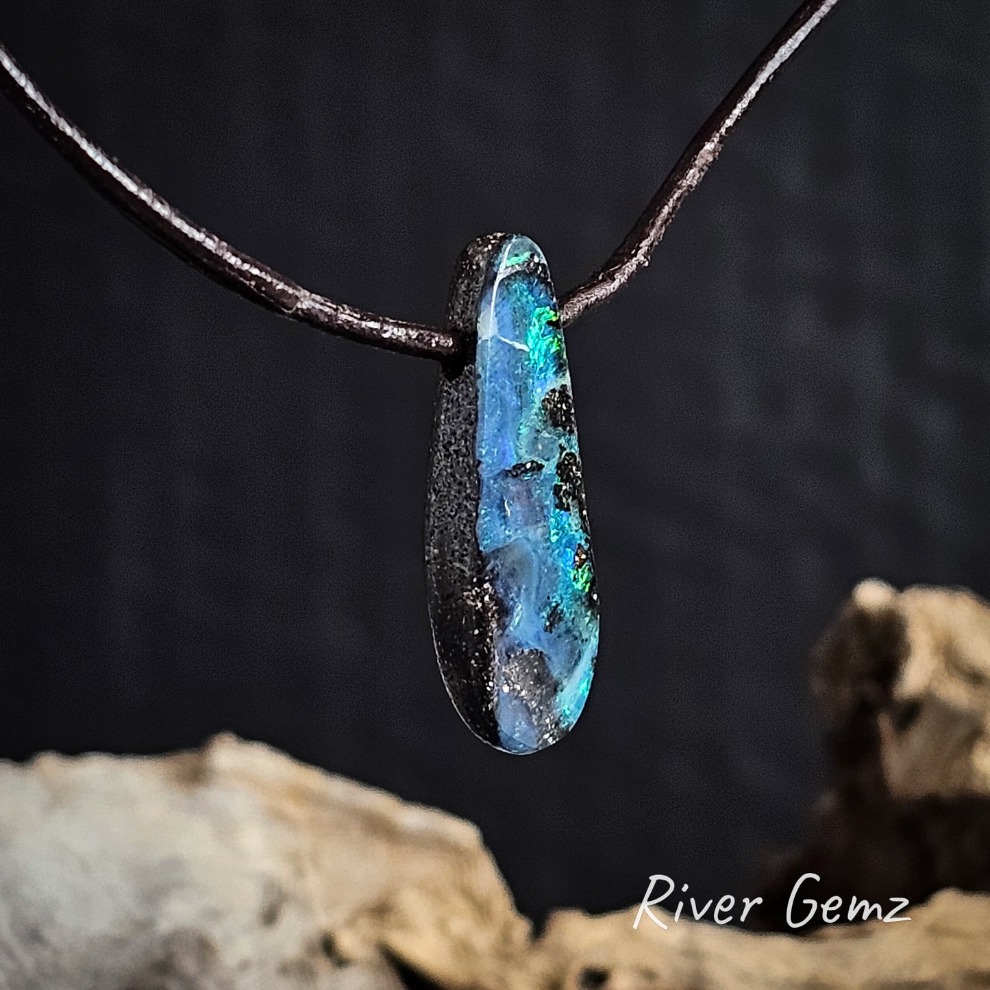 Side view of pendant shows the thickness of the stone on a dark background with 'River Gemz' branding.