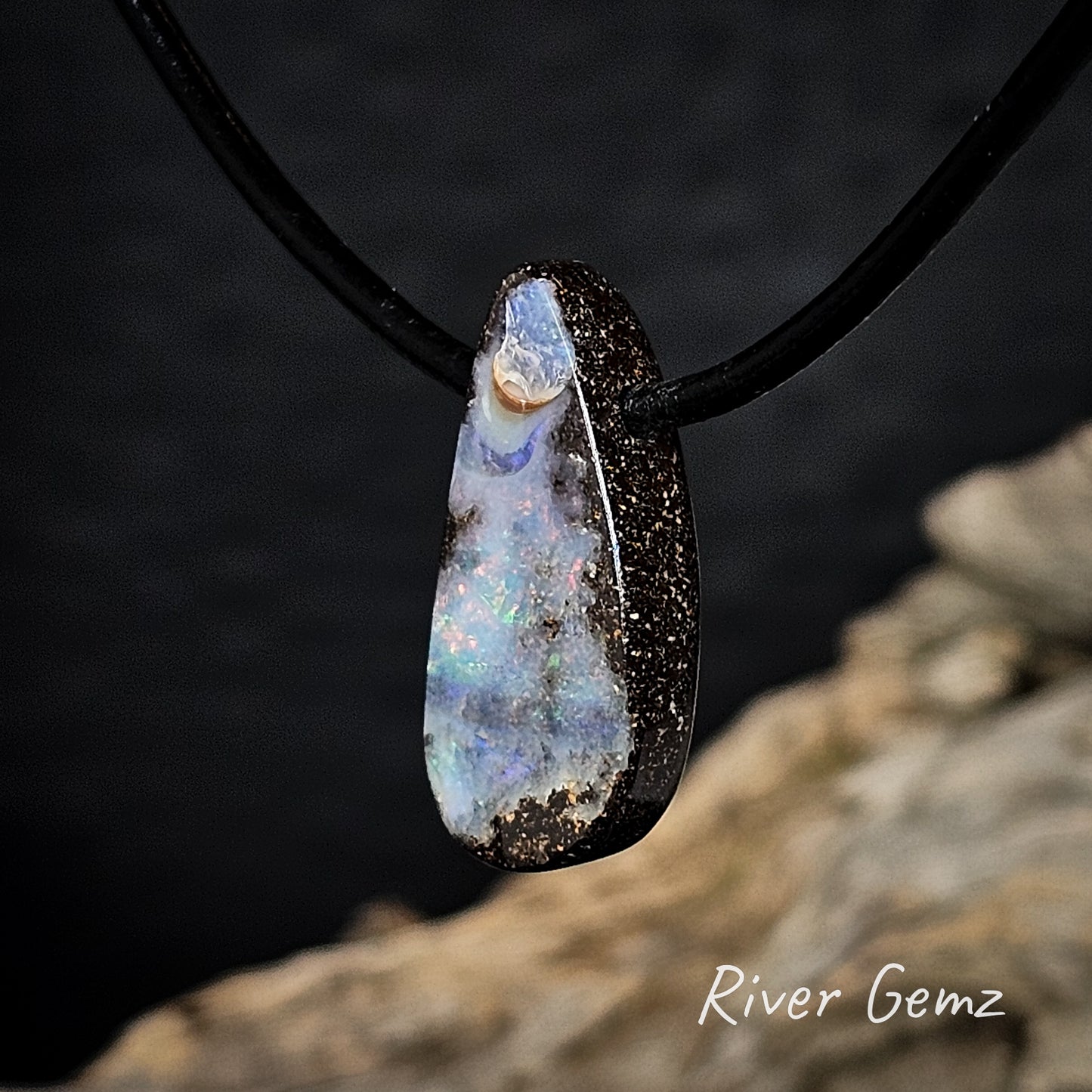 Side view of the pendant shows the thickness of the boulder opal.