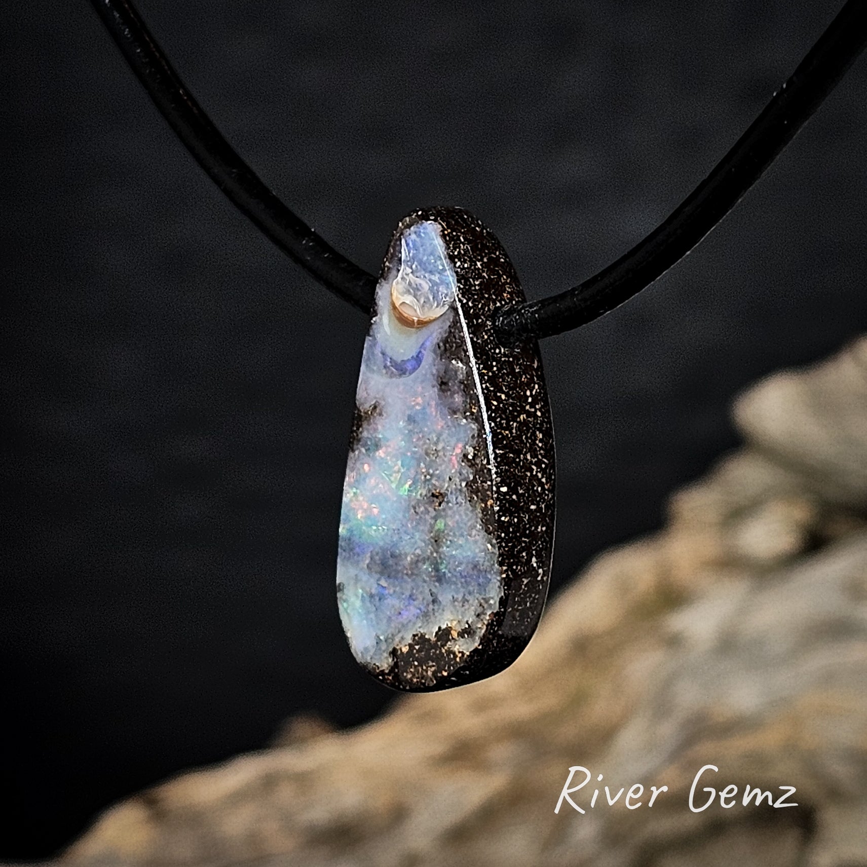 Side view of the pendant shows the thickness of the boulder opal.