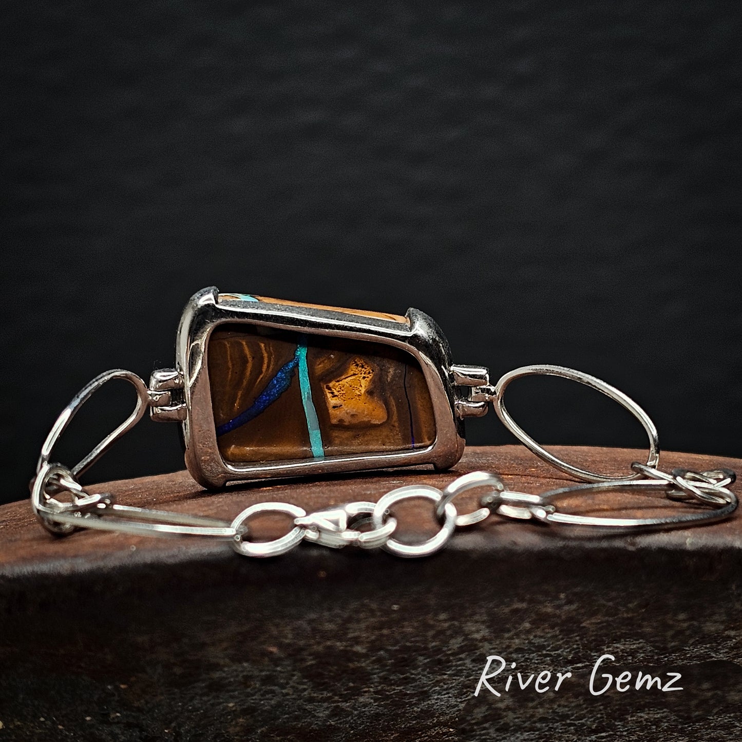 Rear view of silver bracelet showing the ironstone matrix of the boulder opal.