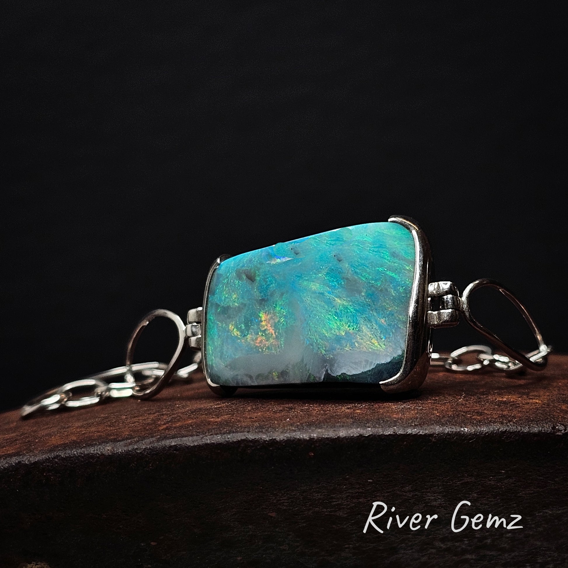 Opal set in sterling silver bracelet on a dark background, featuring the brand 'River Gemz'.