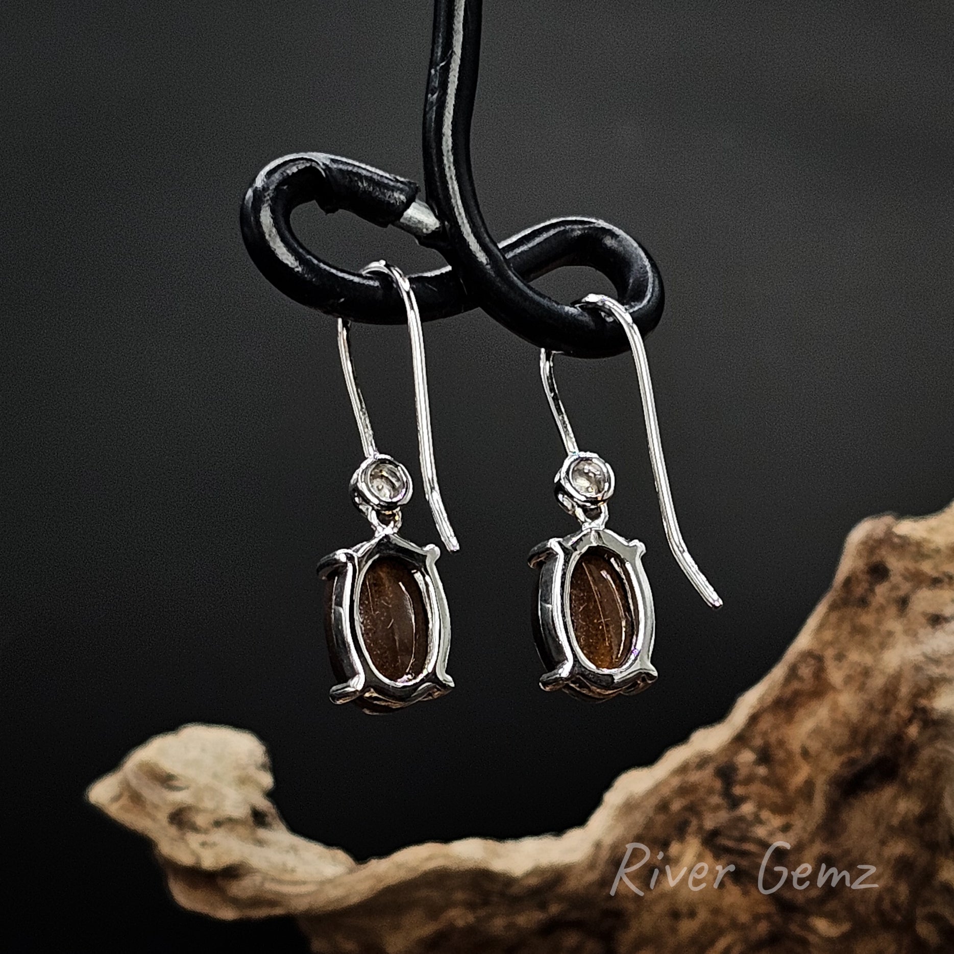Rear view of hook earrings shows the ironstone base of the boulder opals.