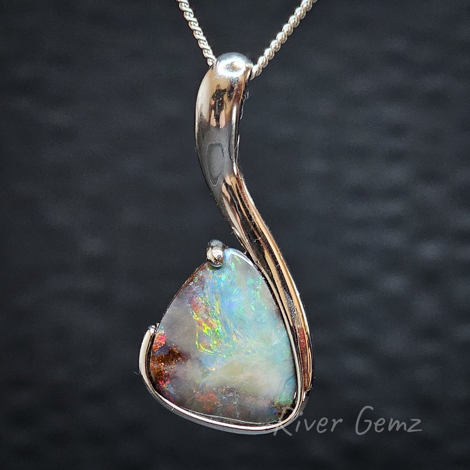 Multi-coloured Queensland boulder opal in a large sterling silver necklace.