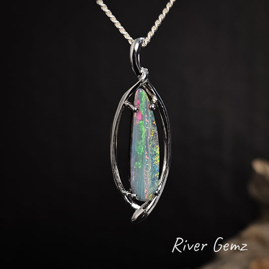 Elongated tear drop shaped multi-coloured opal claw set in silver necklace.
