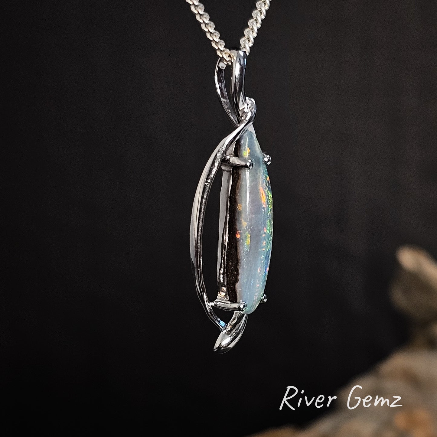 Side view shows the design of the sterling silver setting and the dome of the included boulder opal.