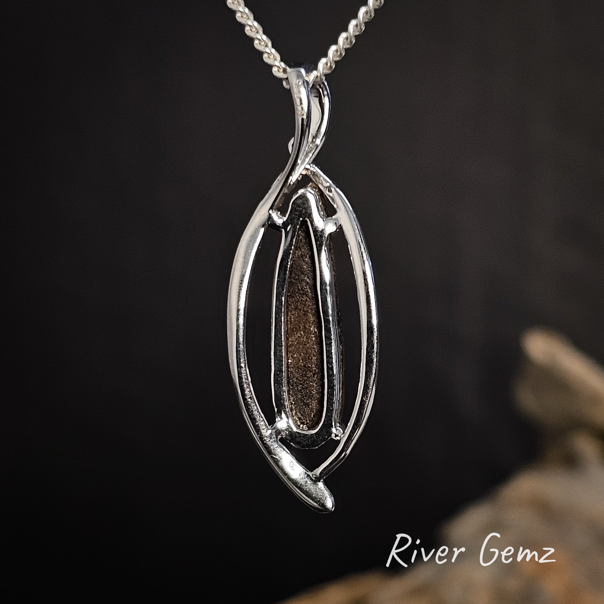 Rear view of the pendant shows the ironstone matrix of the boulder opal.