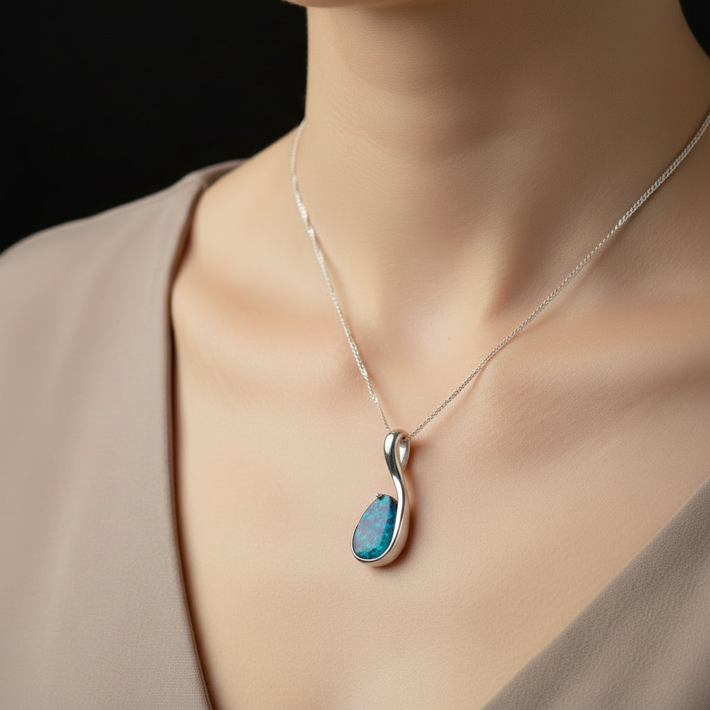 Blue pendant necklace being worn.