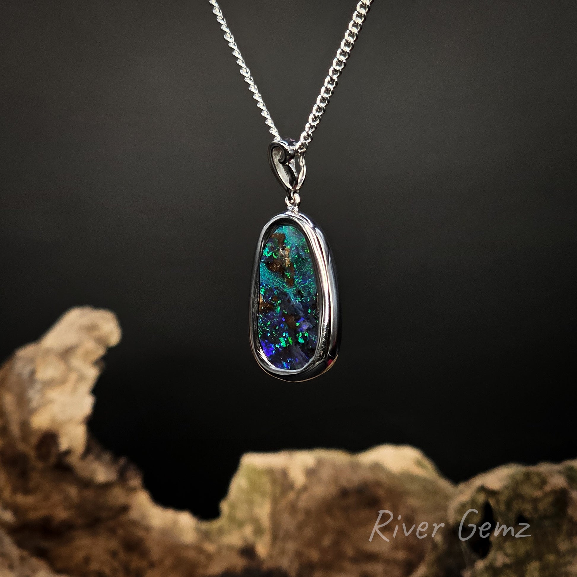 Opal pendant necklace on a dark background with 'River Gemz' branding.