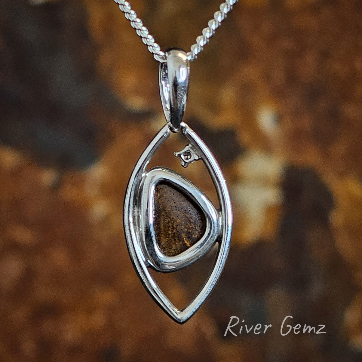 Rear of the sterling silver pendant showing the ironstone of the boulder opal.