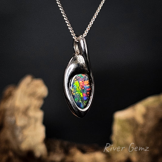 Silver pendant with a colorful boulder opal on a dark background, featuring 'River Gemz' branding.
