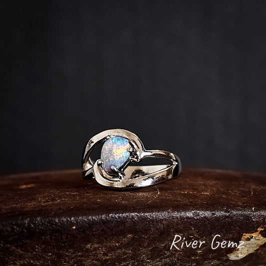 Silver ring with a colourful boulder opal on a dark background, branded 'River Gemz'.